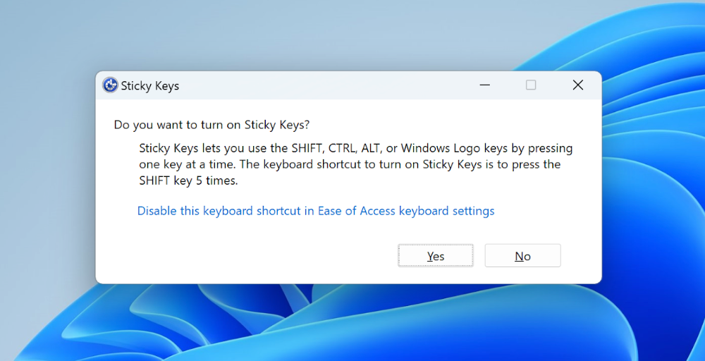 Screenshot of Windows 11 with the Sticky Keys modal activated. The modal asks, “Do you want to turn on Sticky Keys?”
